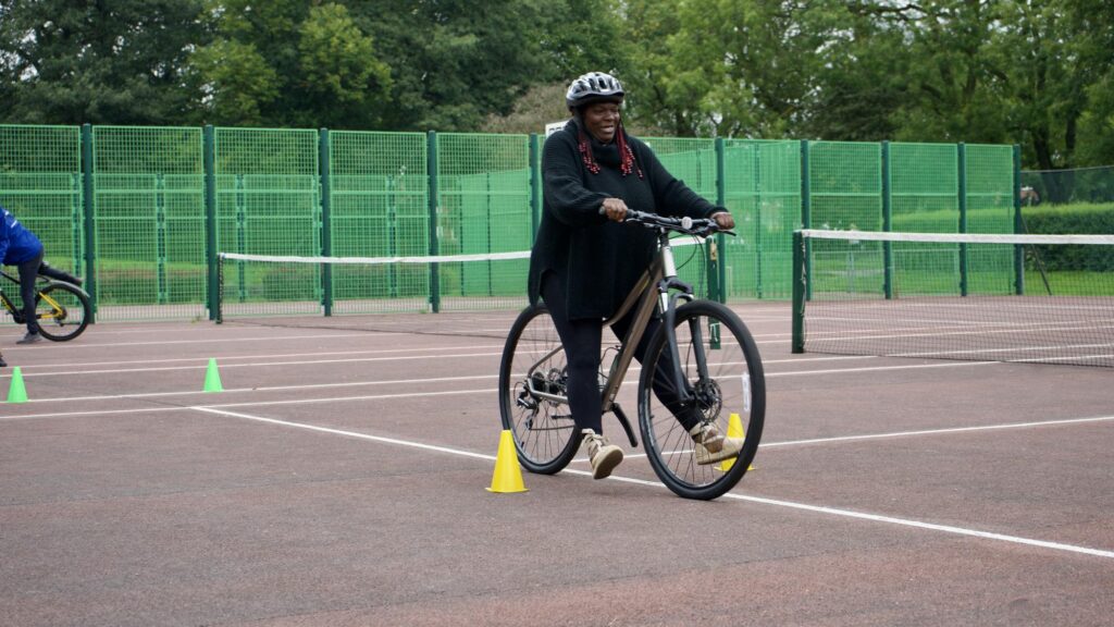 Woman balancing on a bike between cones